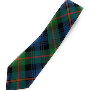 May include: A green, blue, and orange plaid tie. The tie is made of a woven fabric and has a pointed tip.