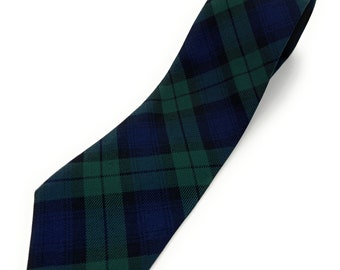 May include: A dark blue and green plaid tie. The tie is made of a silky material and has a pointed tip.