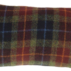 May include: Rectangular pillow with a plaid pattern in shades of red, green, blue, and orange. The pillow has a label that reads "Harris Tweed" and "100% Pure New Wool".