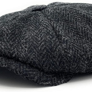 May include: A grey wool newsboy cap with a textured surface.