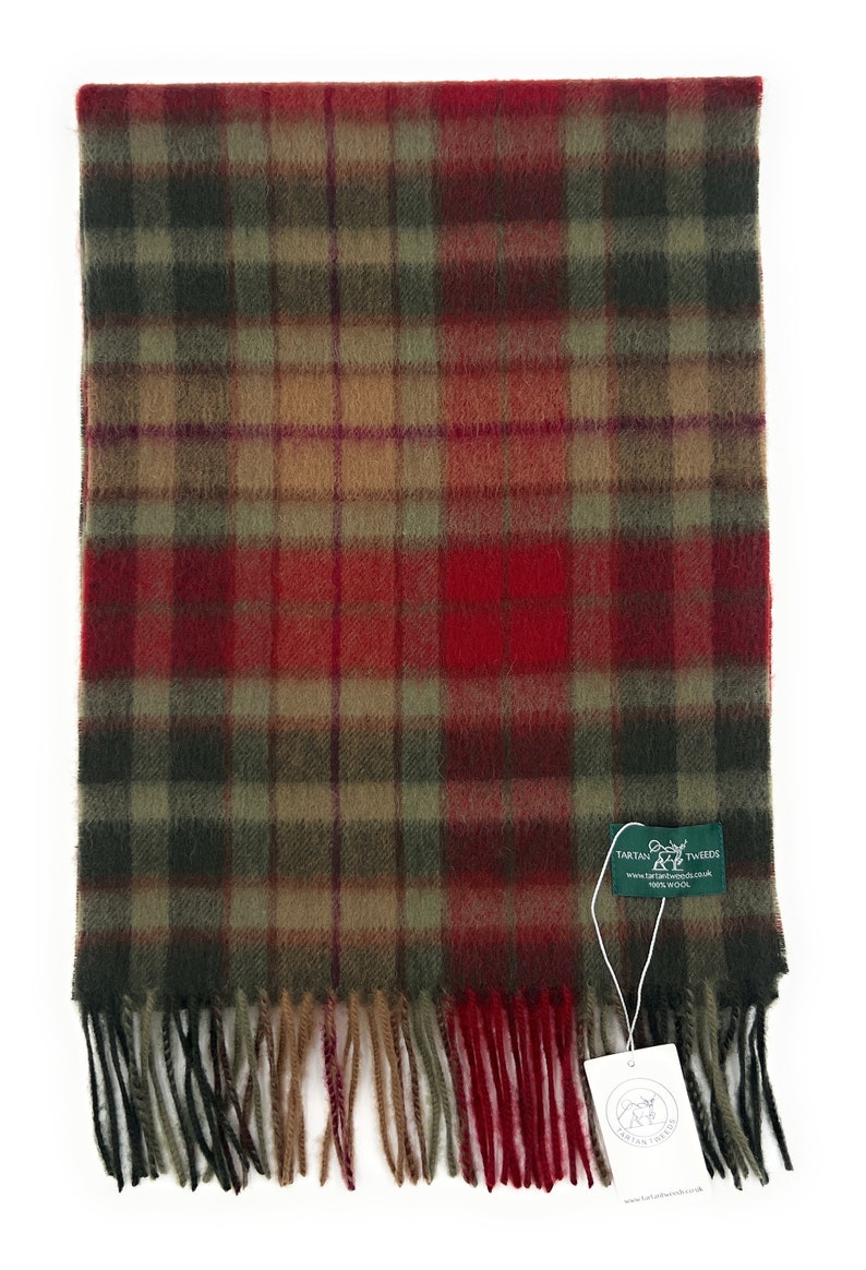 May include: A red, green, and brown plaid scarf with fringed edges. The scarf has a tag attached that reads "Tartan Tweeds, 100% Wool".