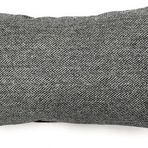 May include: Rectangular pillow with a black and white herringbone pattern. The pillow has a textured appearance and a tag in the lower right corner. The tag has text on it. The pillow is a neutral color and would fit in any room.