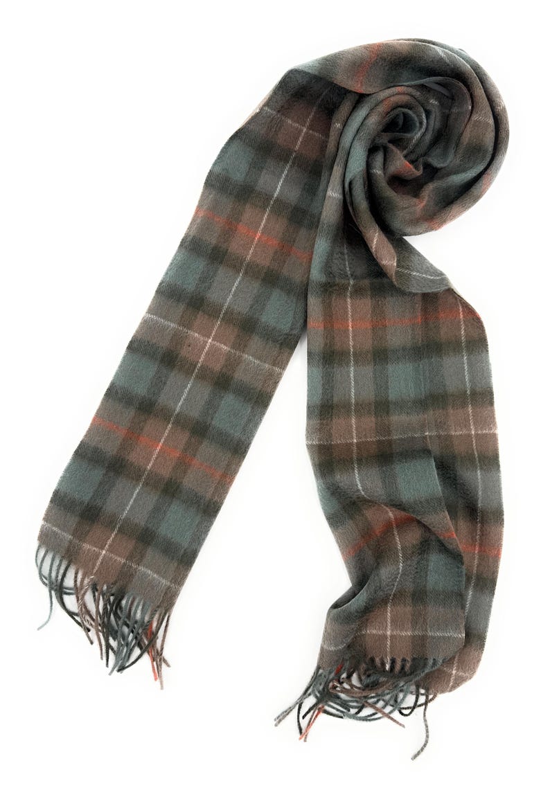 May include: A plaid scarf in shades of gray, brown, and teal with orange accents. The scarf has a fringed edge and is displayed on a white background. The pattern is a classic tartan design.