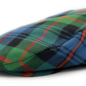 May include: A flat cap in a green, blue, red and black tartan pattern.