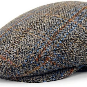 May include: A brown, blue, and orange tweed flat cap with a herringbone pattern.