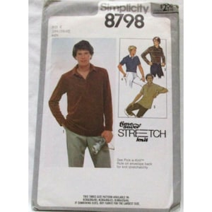 May include: A Simplicity 8798 sewing pattern envelope for a long-sleeve knit shirt. The front displays a brown shirt, illustrations of two variations, and the text: Simplicity 8798, time saver STRETCH knit, and See Pick-a-Knit Rule on envelope back.