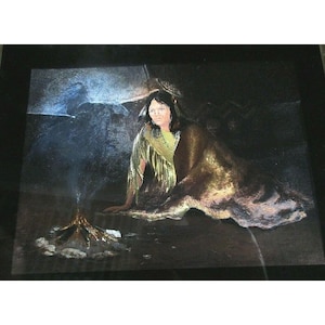 May include: An artistic painting depicts a Native American woman seated near a small fire. She is draped in a golden-brown shawl, with a yellow garment underneath. The background features a dark, shadowy landscape with a hint of blue.