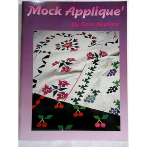 May include: Book cover titled "Mock Applique'" by Sara Nephew. The cover shows a colourful quilt with a range of geometric and floral patterns.