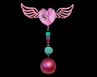 Horror valentine heart with brain imagery and wings.