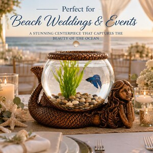May include: A decorative centerpiece for beach weddings and events. It features a glass bowl with a blue fish, green plants, and pebbles, supported by a bronze mermaid sculpture. The text reads "Beach Weddings & Events".