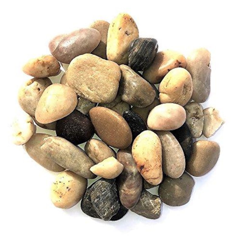 May include: A pile of smooth, rounded river rocks in various shades of brown, tan, and gray. The stones vary in size and shape, with some appearing polished and others more textured. The background is plain white.