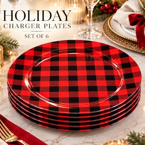 May include: A set of six round charger plates featuring a red and black buffalo plaid pattern. The text HOLIDAY CHARGER PLATES SET OF 6 is printed above the stacked plates. The plates have a smooth, glossy finish and a wide, flat rim.