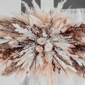 Boho wedding arch decoration with dried flowers. Includes preserved flowers and pampas grass for a natural, rustic look. Perfect for wedding photo zones, these arrangements add a unique touch to your ceremony. Simple, elegant, and handcrafted to fit your boho theme.
