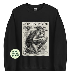 May include: Black sweatshirt with a white graphic print of a goblin with the text "Goblin Mode" above it.