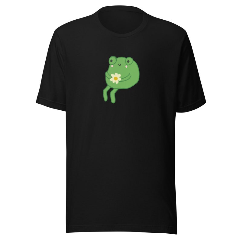 May include: A black t-shirt with a green cartoon frog holding a white flower.