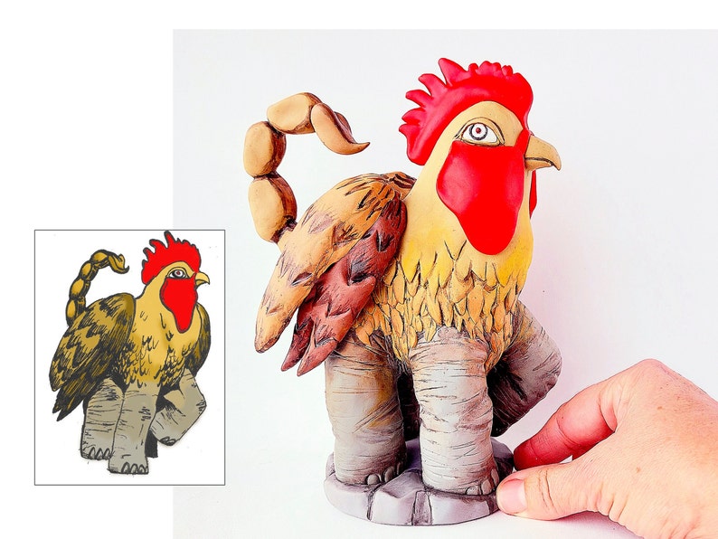 May include: A ceramic sculpture of a rooster with a scorpion tail. The rooster is yellow with a red comb and wattle. The scorpion tail is brown and curled. The sculpture is standing on a brown base.