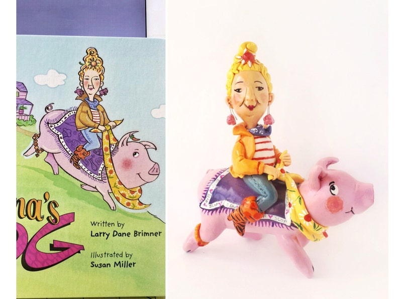 May include: A pink pig with a yellow and white scarf is being ridden by a woman with blonde hair and a yellow jacket. The woman is wearing a blue and white striped shirt and blue jeans. The pig is wearing a purple and blue saddle. The book cover reads "Grandma's Pig" with the author and illustrator's names listed below.