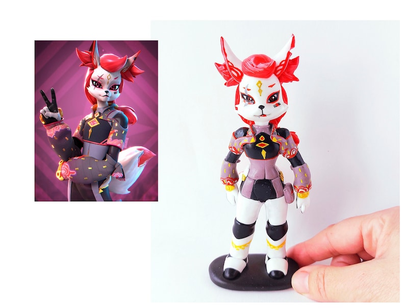 May include: A hand-painted figurine of a red-haired fox-like character wearing a black and purple outfit with gold accents. The figurine is standing on a black base.