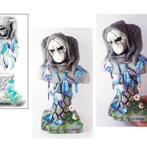 May include: A grey and white ceramic bust of a hooded figure with a skull-like face. The bust is decorated with blue and white feathers and flowers. The base of the bust is made of grey stone and has the words "&Theta;&upsilon;&mu;&eta;&theta;&epsilon;ί&sigmaf; &Mu;&omicron;&rho;&phi;έ&sigmaf;" written on it.