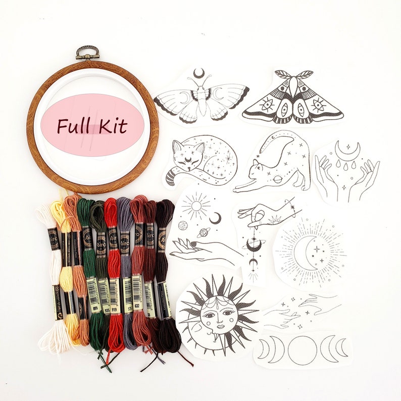 May include: A full embroidery kit with a wooden hoop, embroidery floss in various colors, and several black and white celestial-themed iron-on patches. The patches include moths, cats, hands, moons, and suns.