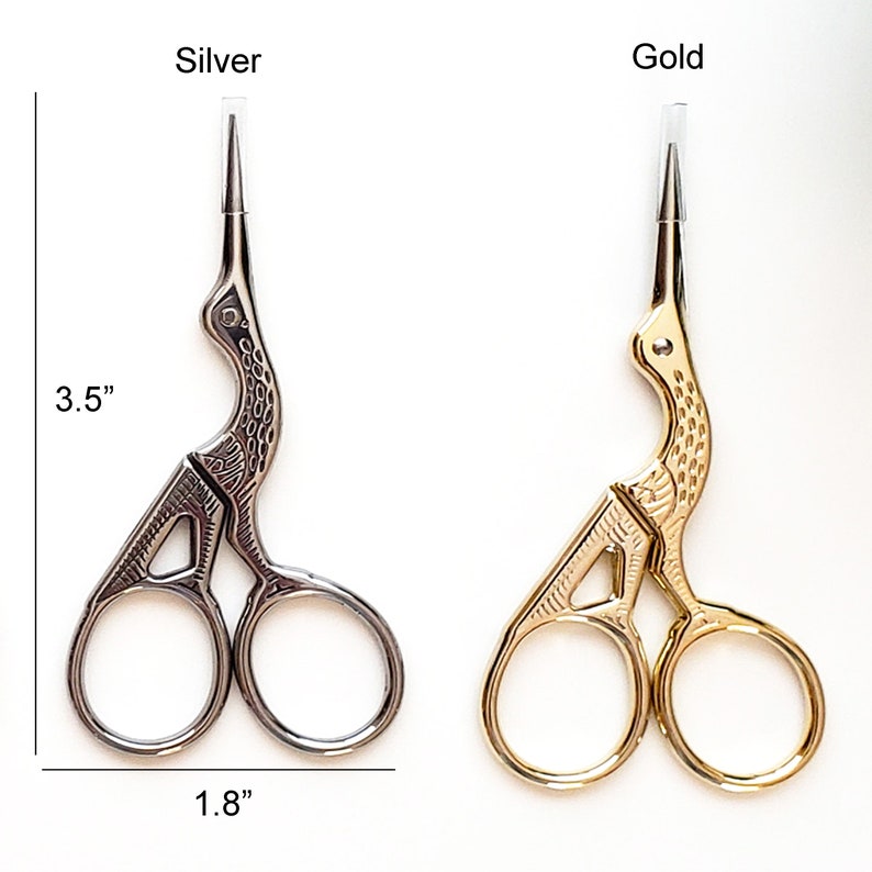 May include: Silver and gold-colored embroidery scissors. The silver scissors are 3.5 inches long and 1.8 inches wide. The gold scissors are the same size. Both scissors have a bird-like design and are on a white background.