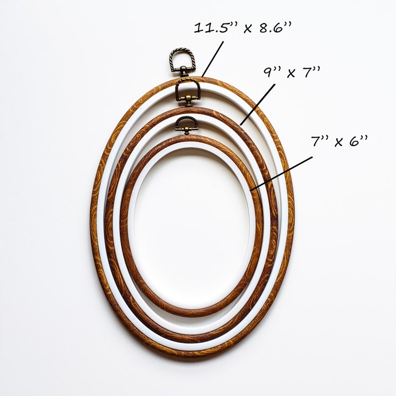 May include: Three oval embroidery hoops in varying sizes. The largest hoop measures 11.5" x 8.6", the middle one is 9" x 7", and the smallest is 7" x 6". Each hoop has a wooden outer ring and a white inner ring, with a metal clasp.