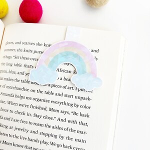 May include: A rainbow-colored bookmark with a cloud design and the text "African Kids Say" and "A beautiful piece of art."