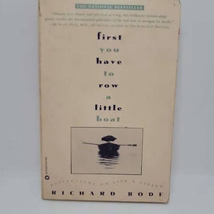 May include: Book cover with the title "first you have to row a little boat" by Richard Bode. The cover features a black and white photo of a small boat on a body of water.
