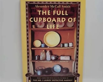 The Full Cupboard of Life by Alexander McCall Smith No. 1 Ladies' Detective Agency #5 Mma Ramotswe, who became engaged to Mr J.L.B. Mat