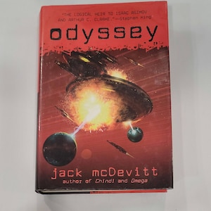 May include: A red book cover with a spaceship and a planet in the background. The title of the book is "odyssey" and the author is "jack mcDevitt". The text on the cover reads "The logical heir to Isaac Asimov and Arthur C. Clarke." - Stephen King.