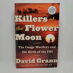 May include: A book cover with a red, orange, and yellow sunset background. The title is "Killers of the Flower Moon" in large, bold, white letters. The subtitle is "The Osage Murders and the Birth of the FBI" in smaller, white letters. The author's name, "David Grann", is in large, bold, white letters. The book cover also features a small, black and white image of an oil derrick.