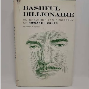 May include: A white book cover with the title "Bashful Billionaire: An Unauthorized Biography of Howard Hughes" by Albert B. Gerber. The cover features a green and white halftone illustration of Howard Hughes's face.