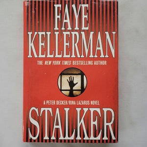 May include: A red and black striped book cover with the title "STALKER" in white letters. The author's name, "FAYE KELLERMAN", is printed in white letters above the title. The book cover also features a silhouette of a hand reaching out from a window.