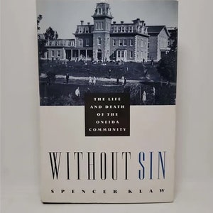 May include: A black and white photo of a large brick building with a grassy lawn in front. The text "The Life and Death of the Oneida Community" is above the title "Without Sin" by Spencer Klaw.