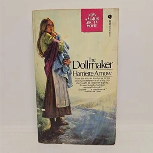 May include: A paperback book cover with a woman holding a baby. The book is titled "The Dollmaker" by Harriette Arnow. The cover features a woman in a purple and blue dress, holding a baby wrapped in a blue blanket. The book is set against a backdrop of a mountain range.