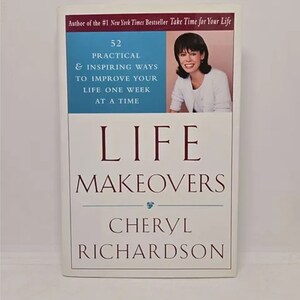 May include: A book titled "Life Makeovers" by Cheryl Richardson. The book cover features a woman with brown hair and a white shirt. The subtitle is "52 Practical & Inspiring Ways to Improve Your Life One Week at a Time".