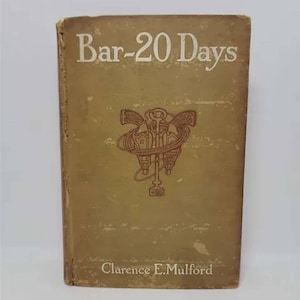May include: A vintage book titled "Bar-20 Days" by Clarence E. Mulford. The cover is a light brown color with a red and brown illustration of two pistols crossed with a key.