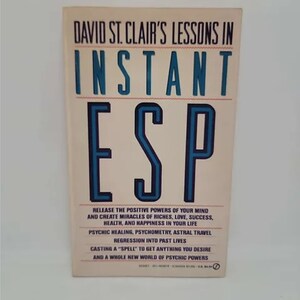 May include: Book cover with a white background and blue text that reads "David St. Clair's Lessons in Instant ESP". The text below the title reads "Release the positive powers of your mind and create miracles of riches, love, success, health, and happiness in your life. Psychic healing, psychometry, astral travel regression into past lives. Casting a "spell" to get anything you desire and a whole new world of psychic powers."