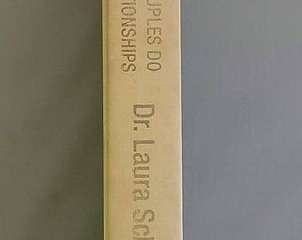 May include: A book titled "10 Stupid Things Couples Do To Mess Up Their Relationships" by Dr. Laura Schlessinger. The book cover is beige with gold lettering.