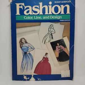 May include: A blue book titled "Fashion: Color, Line, and Design, Third Edition" by Susan Geringer. The cover features illustrations of fashion designs.