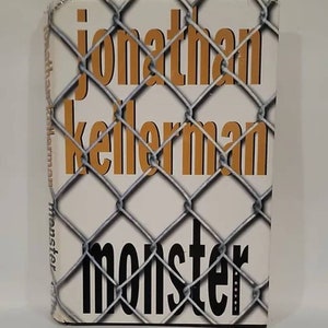 May include: A book cover with a chain link fence pattern. The title "Monster" is in large black letters. The author's name "Jonathan Kellerman" is in smaller orange letters.