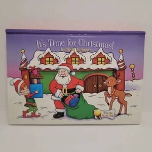 May include: A purple and pink book cover with the title "It's Time for Christmas!" by Mitch Fujimoto. The cover features Santa Claus with a bag of presents, an elf carrying a box, and a reindeer.