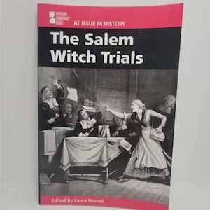 May include: A black and white illustration depicting a scene from the Salem Witch Trials. The image shows a group of men in formal attire, seated at a table, with a woman standing and gesturing towards them. The text "The Salem Witch Trials" is printed in white on a black background.