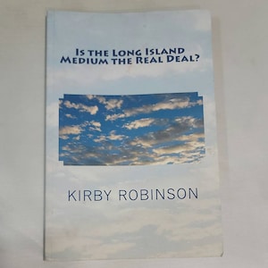 May include: Book cover with a blue sky and white clouds background. The title is "Is the Long Island Medium the Real Deal?" and the author is "Kirby Robinson".