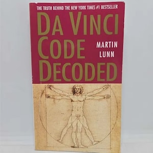 May include: A red book with the title "Da Vinci Code Decoded" by Martin Lunn. The book cover features a drawing of a man in a circle.
