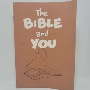 May include: A book cover with the title "The Bible and You" in white, bold letters. Below the title is a simple illustration of a person reading a book. The background is a solid, muted orange color.