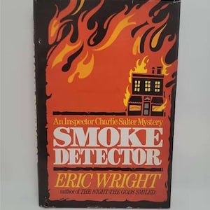 May include: A book cover with a red and black background. The cover features a burning building with flames in the background. The title of the book is "Smoke Detector" and the author is "Eric Wright".