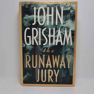 The Runaway Jury: A Novel Hardcover – May 1, 1996 by John Grisham #1 New York Times Bestseller • Every jury has a leader, and the verdi