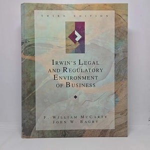 May include: A book titled "Irwin's Legal and Regulatory Environment of Business" by F. William McCarty and John W. Bagby. The book cover features a green, brown, and white abstract design with a red diamond shape.