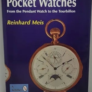 May include: A Schiffer Book for Collectors book cover featuring a gold pocket watch with a white face and multiple subdials. The book title is "Pocket Watches: From the Pendant Watch to the Tourbillon" by Reinhard Meis.